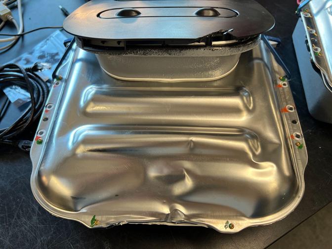 Battery lid bent significantly with sealing compromised