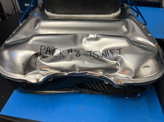 Battery lid widely bent with significant cracking